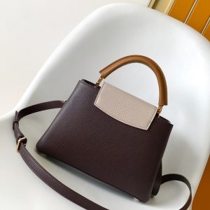 Alternative view of p125031.05 x 20.0 x 11.0 cm (L x H x W) 27.0 x 17.3 x 9.0 cm (L x H x W) 21.0 x 13.6 x 8.0 cm (L x H x W) • Taurillon calf leather • Calf leather trim •Cowhide leather lining•Metal hardware•Flap can be positioned inside or outside•Zippered interior pocket•Interior patch pocket•Metal studs•Holds smartphone, LV Vertical wallet, headphones, and keys•Strap: Detachable, adjustable•Strap half-length: 45.5 cm•Strap half-length adjustable to: 53.0 cm•Handle: Single handle